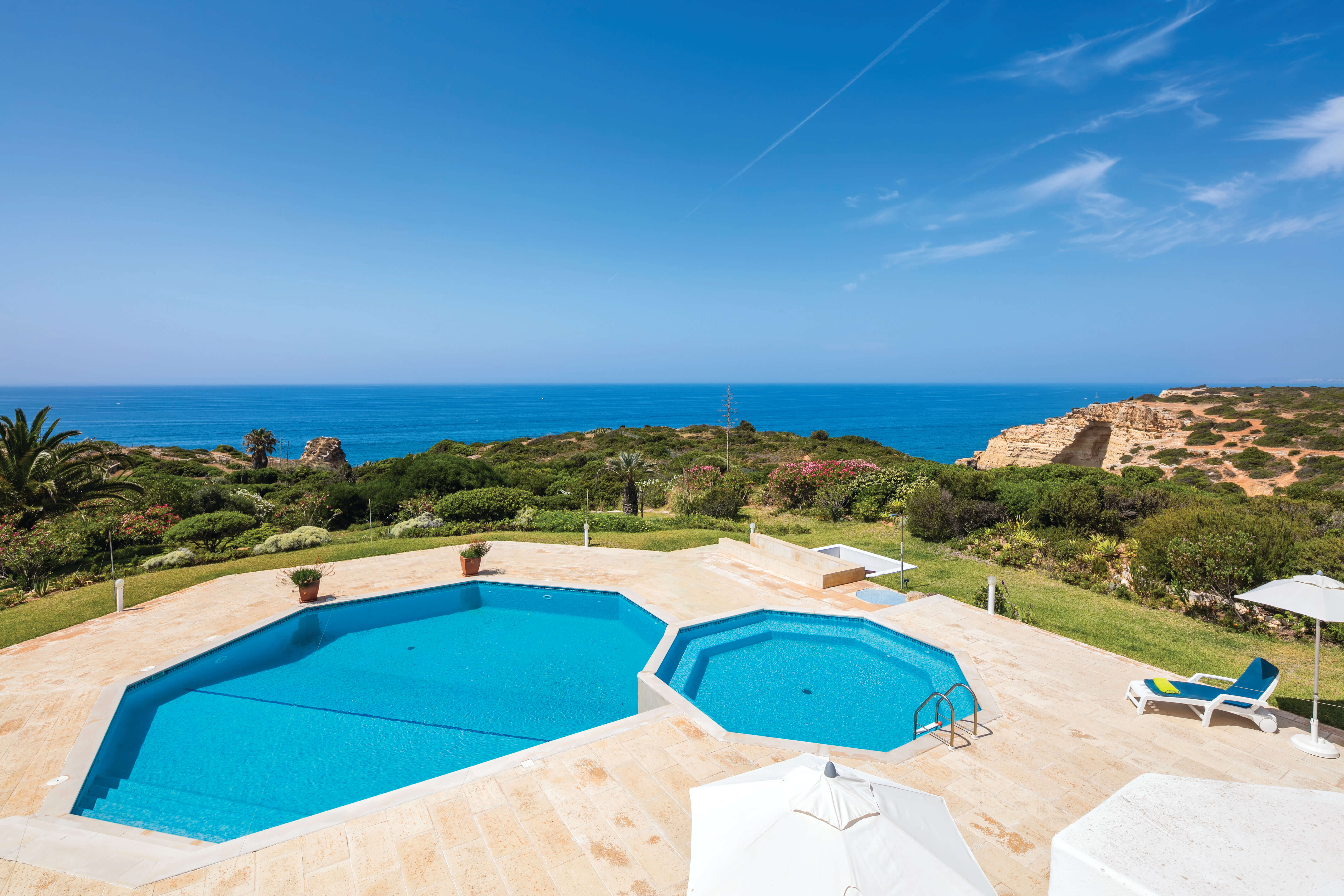 A stunning image of a luxury villa in the Algarve with ocean views.